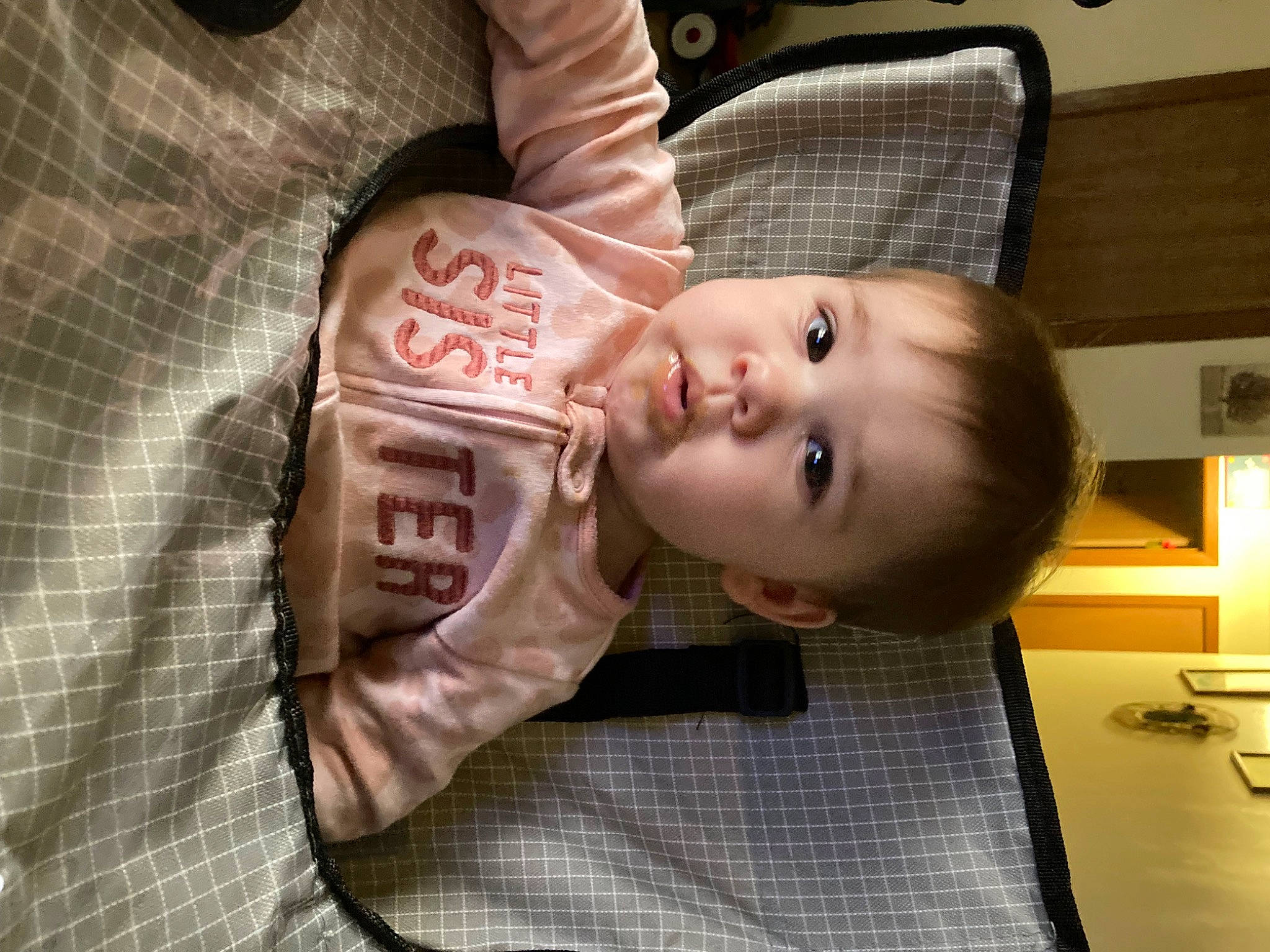 Lyla is registered to the contest to win money with this photo: baby, baby_products, baby_toddler_clothing, carmine, cheek, child, chin, comfort, flooring, fun, happy, lip, mouth, nose, person, room, sitting, skin, smile, toddler