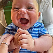 Lowen joined the competition — help win amazing prizes! baby, child, smiling, happy, blue_striped_shirt, hands, adult, supporting, close_up, portrait, cute, infant, skin, fingers, joy, expression, person, casual_clothing, indoors, family