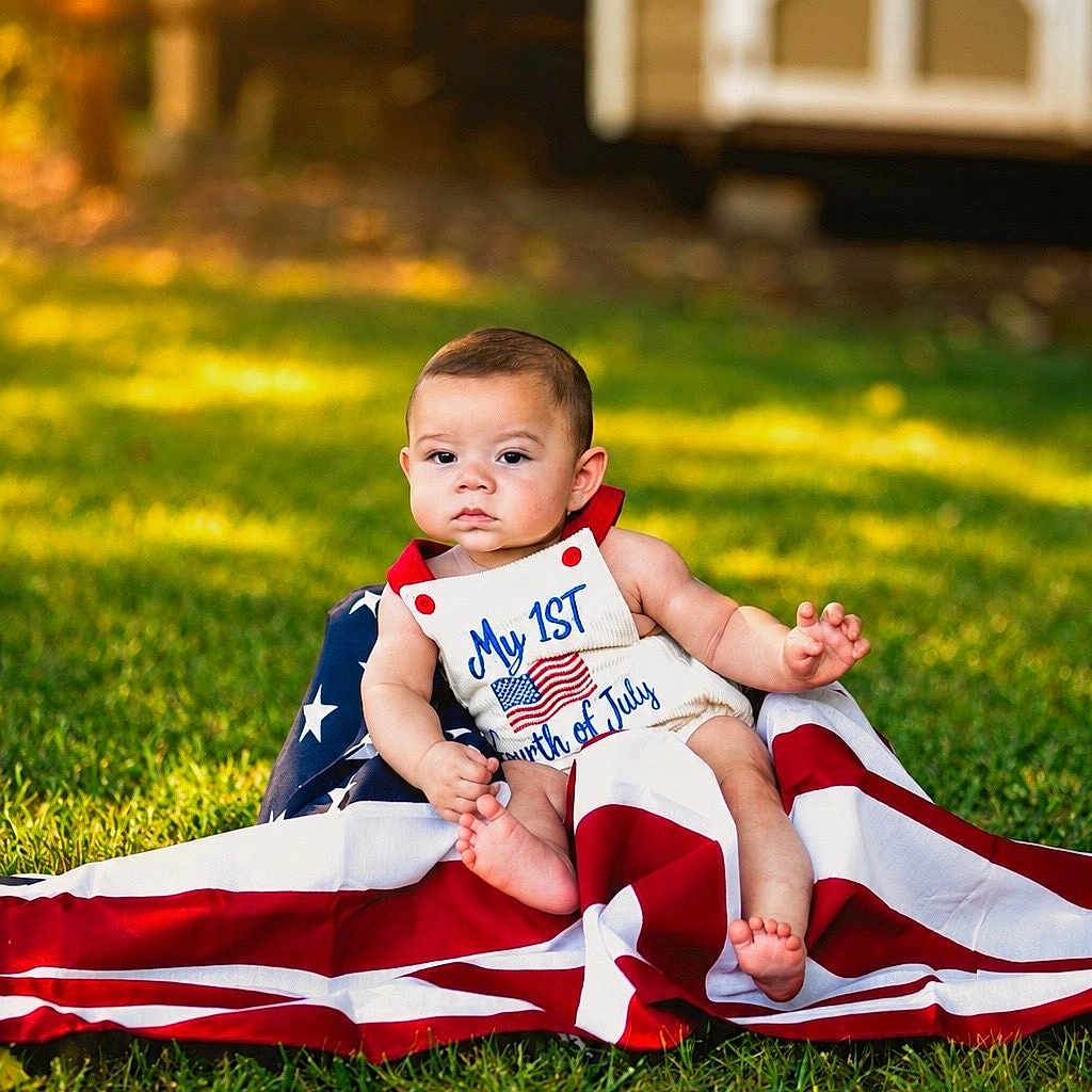 Lowen joined the competition — help win amazing prizes! baby, infant, grass, outdoor, flag, american_flag, patriotic, clothing, cute, child, summer, celebration, holiday, red, white, blue, portrait, sitting, nature, sunlight