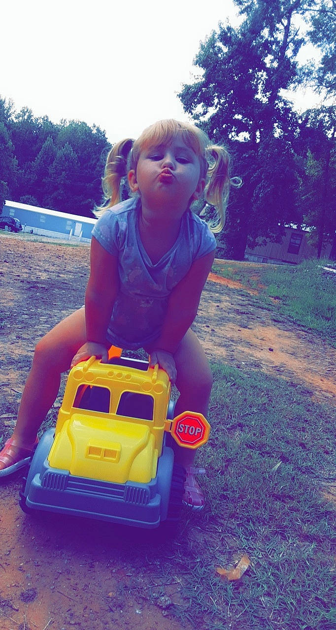 Adalina joined the competition — help win amazing prizes! automotive_exterior, car, fun, grass, motor_vehicle, person, tree, vacation, vehicle, yellow