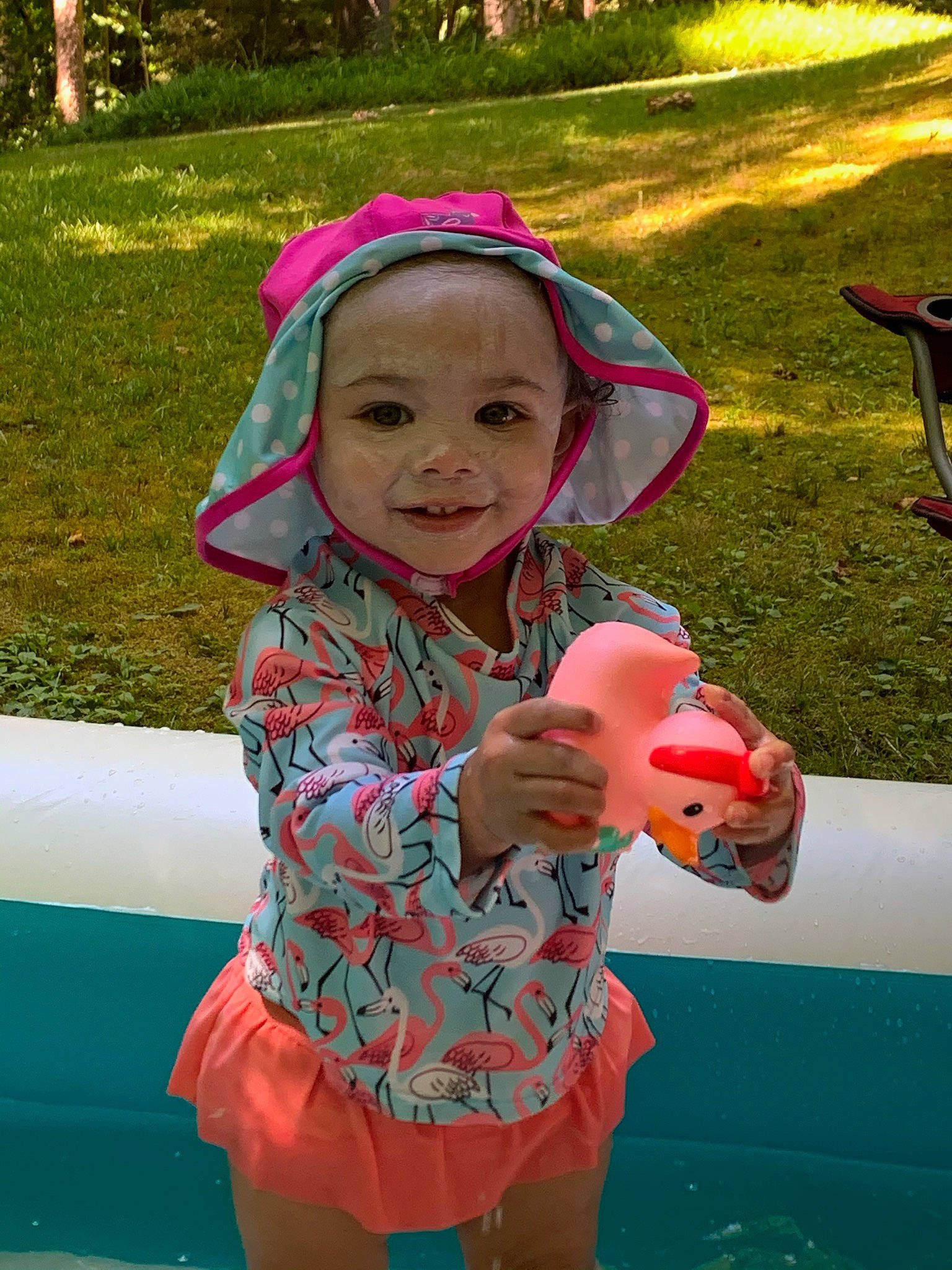 Lydia is registered to the contest to win money with this photo: baby_toddler_clothing, child, eye, fun, grass, green, happy, headwear, joy, leisure, mouth, person, photograph, pink, plant, public_space, red, skin, smile, summer