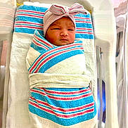 Raikishori joined the competition — help win amazing prizes! newborn, baby, hospital, blanket, bassinet, wrapped, hat, striped, sleeping, infant, cute, peaceful, bed, white, red, blue, person, portrait, child, medical