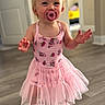 baby, ballet, barefoot, blonde_hair, child, cute, daylight, doorway, girl, hands, home, indoors, pacifier, pink_dress, portrait, smiling, standing, toddler, tutu, wood_floor