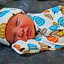 James is registered to the contest to win money with this photo: newborn, baby, sleeping, infant, cozy, hat, clothing, patterned, pumpkin, cute, soft, portrait, resting, child, young, wrapped, warm, face, peaceful, indoors
