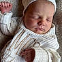 baby, newborn, sleeping, knitted_hat, knitted_sweater, white_clothing, infant, soft_blanket, peaceful, closeup, portrait, cute, child, resting, cozy, tiny_fingers, face, sleep, warm, soft_texture