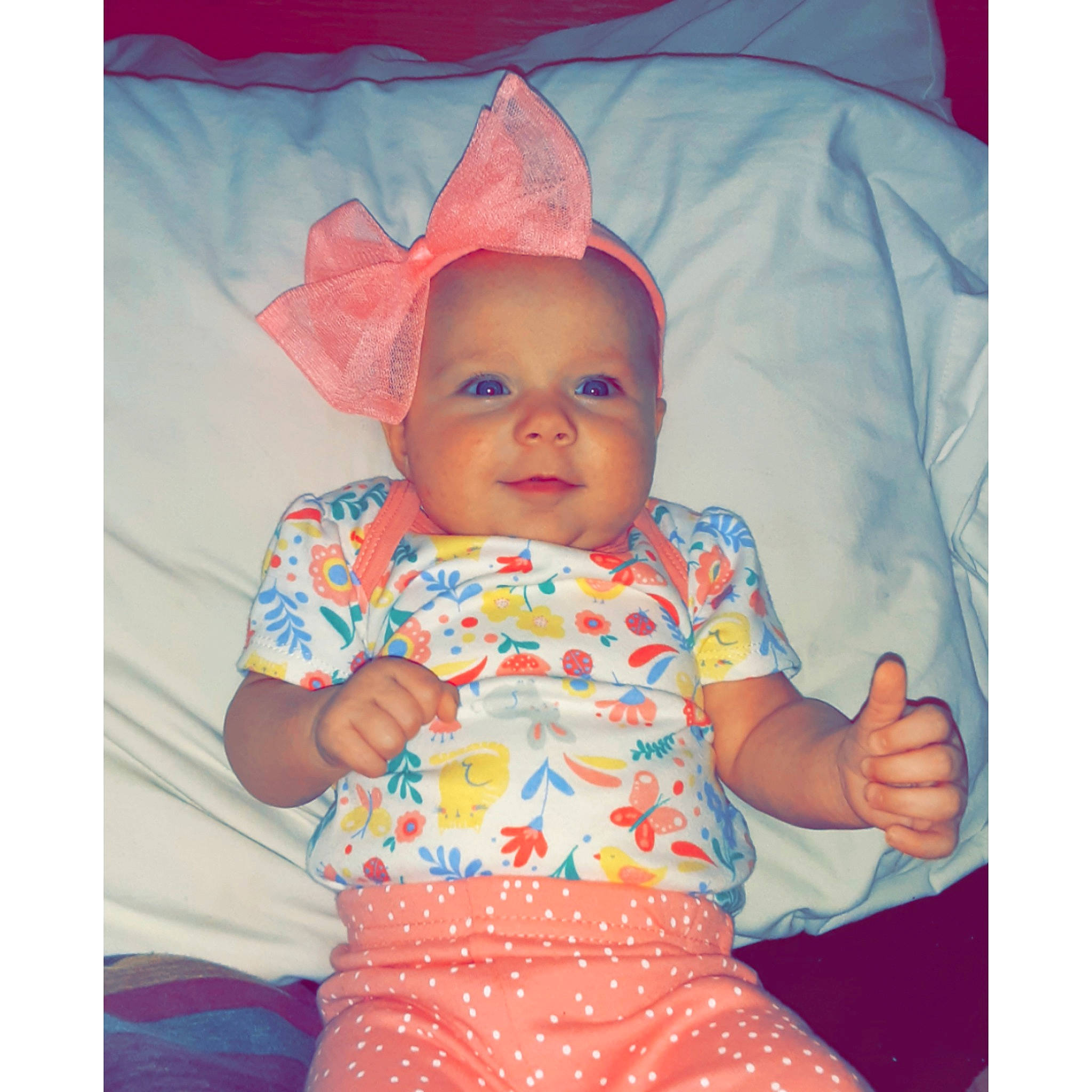 Jacqueline is registered to the contest to win money with this photo: baby, baby_products, baby_toddler_clothing, bonnet, child, costume_accessory, costume_hat, headwear, linens, orange, peach, person, pink, toddler