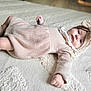 Julia participe au concours pour gagner de l'argent avec cette photo : baby, blanket, bow, child, comfortable, cute, footwear, hand, headband, indoors, infant, knitwear, laying_down, portrait, relaxed, skin, socks, soft, texture, warm_clothing