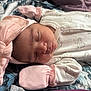 baby, baby_accessories, baby_clothing, blanket, closeup, cute, headband, indoor, infant, mittens, newborn, onesie, patterned_blanket, peaceful, pink_bow, portrait, resting, sleep, sleeping, soft_fabric