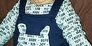 Tyler a rejoint le concours — aidez-le/la à gagner de superbes lots ! baby, bodypart, clothing, dress, face, happy, head, homedecor, jeans, laughing, mouth, pants, person, photography, portrait, shirt, smile, t_shirt, teeth, vest