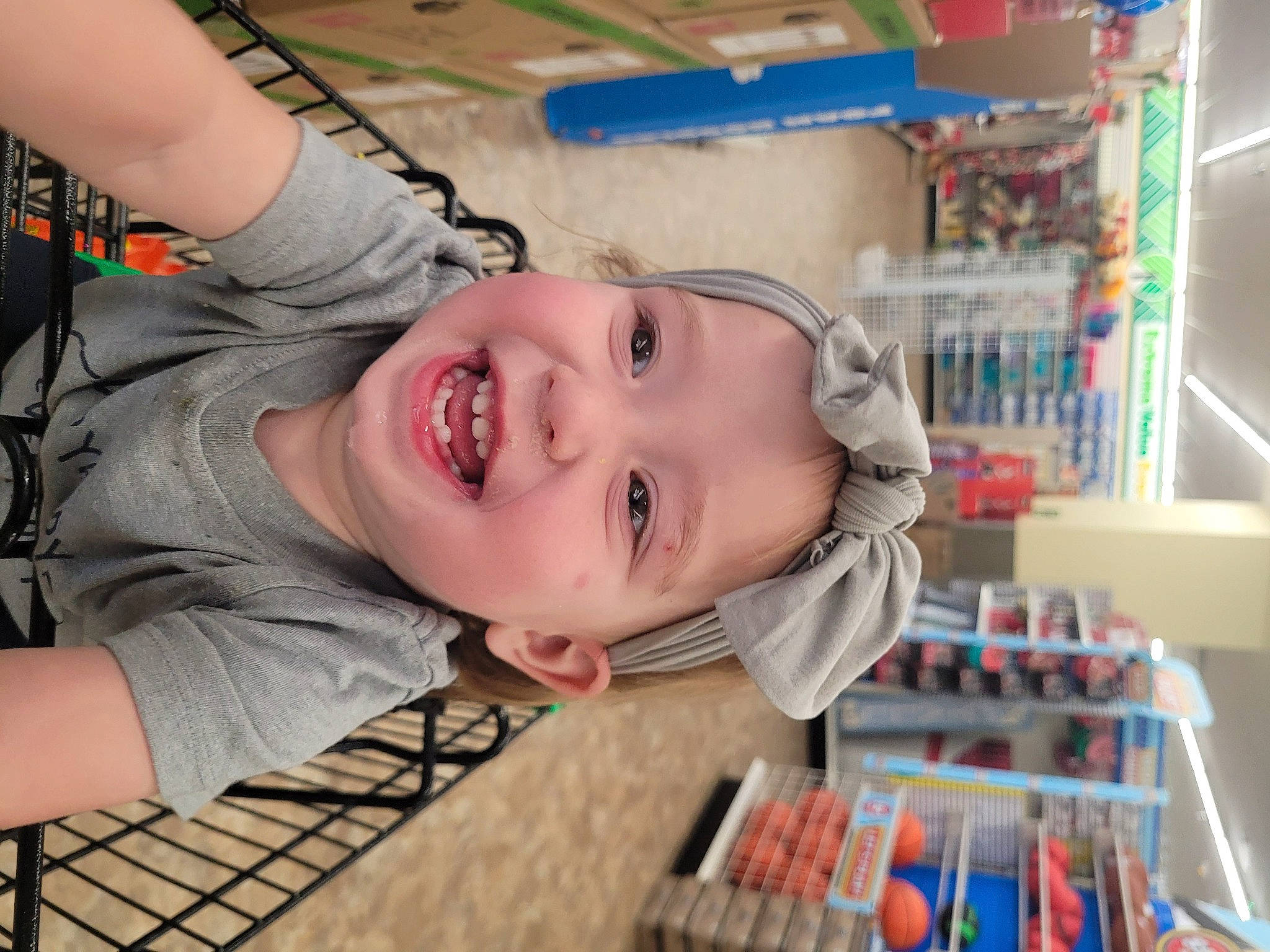 Lindsay is registered to the contest to win money with this photo: cheek, child, chin, eyelash, fun, happy, laugh, leisure, mouth, nose, person, play, product, refrigerator, room, shelf, shelving, skin, smile, toddler