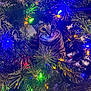 cat, tabby_cat, christmas_tree, christmas_lights, colorful_lights, pine_needles, holiday, festive, pet, animal, indoor, green, closeup, curious, cute, feline, nature, decorations, playful, christmas