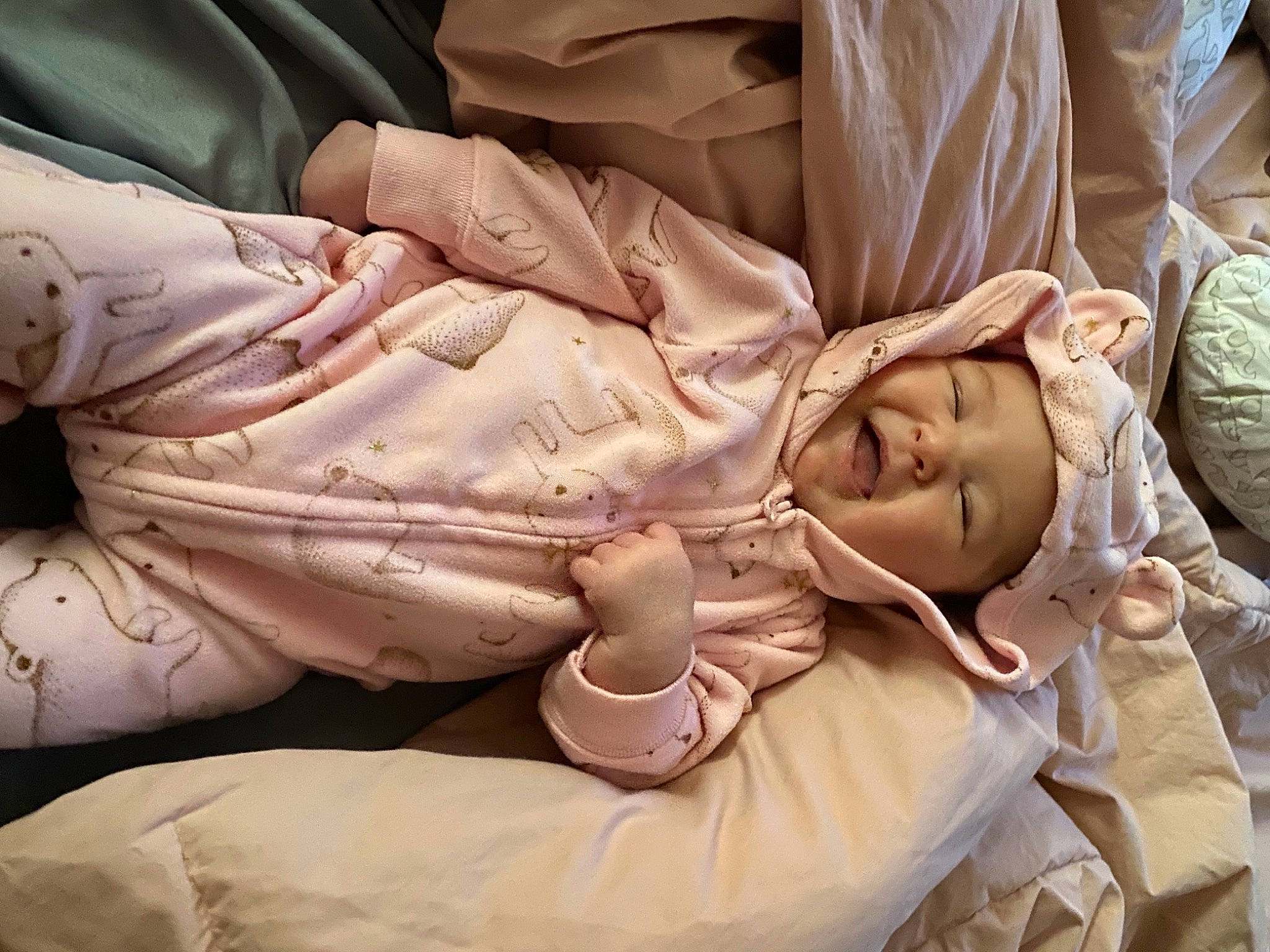 Kynlee is registered to the contest to win money with this photo: abdomen, arm, baby, bed, bedding, chest, child, comfort, dress, finger, headwear, human_body, human_leg, linens, mammal, person, room, sitting, textile, toddler