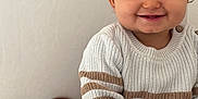 Tilyano participe au concours pour gagner de l'argent avec cette photo : baby, casual, child, clothing, cozy, cute, face, happy, home, indoor, knitwear, light_skin, person, portrait, seated, short_hair, smiling, striped, sweater, toddler