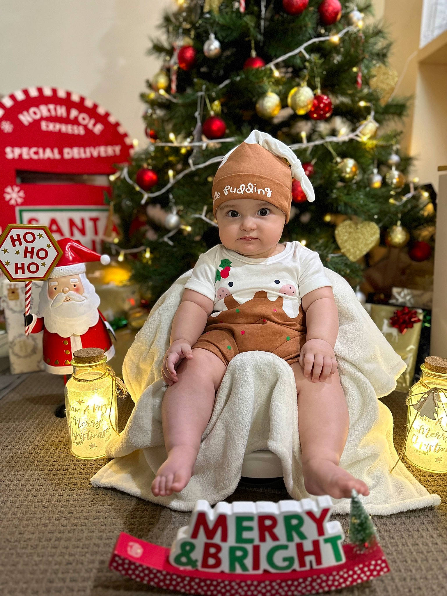 Aerys is registered to the contest to win money with this photo: baby_toddler_clothing, child, christmas, christmas_decoration, christmas_eve, christmas_ornament, christmas_tree, conifer, event, happy, headwear, holiday, holiday_ornament, interior_design, ornament, person, plant, sitting, toddler, tradition