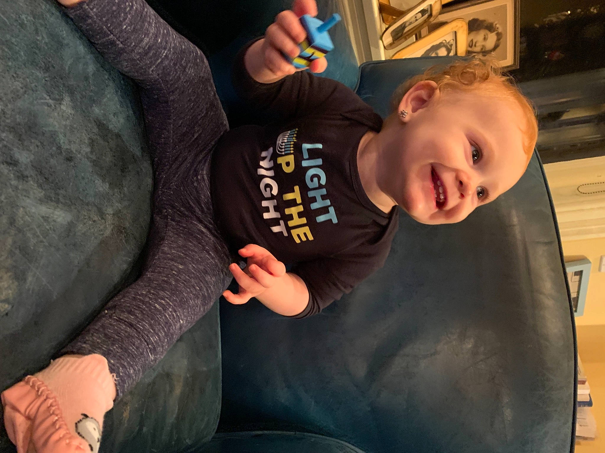 Ember is registered to the contest to win money with this photo: auto_part, automotive_exterior, automotive_tire, baby, blurred, bumper, child, electric_blue, finger, fun, happy, joy, leisure, mouth, person, recreation, sitting, sleeve, smile, t_shirt