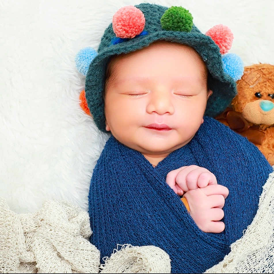 Neev is registered to the contest to win money with this photo: baby, beanie, blanket, bodypart, bonnet, cap, clothing, face, finger, hand, hat, head, hood, newborn, person, photography, portrait, sleeping, teddybear, toy