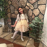 Mariapaula joined the competition — help win amazing prizes! child, girl, dress, tights, shoes, stone_wall, fireplace, plant, indoor, smile, pose, long_hair, floor, home_decor, basket, carpet, joy, fashion, portrait, cute