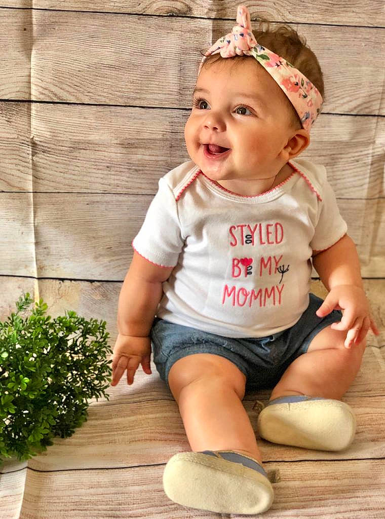 Ilianys Suarez joined the competition — help win amazing prizes! baby, baby_toddler_clothing, child, child_model, fashion_accessory, floor, flooring, hair_accessory, happy, headband, headgear, headwear, person, photography, play, product, sitting, sleeve, smile, t_shirt