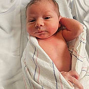 Emmanuel joined the competition — help win amazing prizes! newborn, baby, infant, child, portrait, face, eyes_open, looking_at_camera, swaddled, blanket, hospital, bedding, lying_down, skin, hair, indoors, close_up, soft_lighting, relaxed, photography