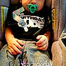 baby, child, infant, car_seat, pacifier, blanket, sleepy, portrait, face, hands, brown_hair, birthday_shirt, seated, indoor, vehicle, safety_straps, text_overlay, timestamp, cozy, photography