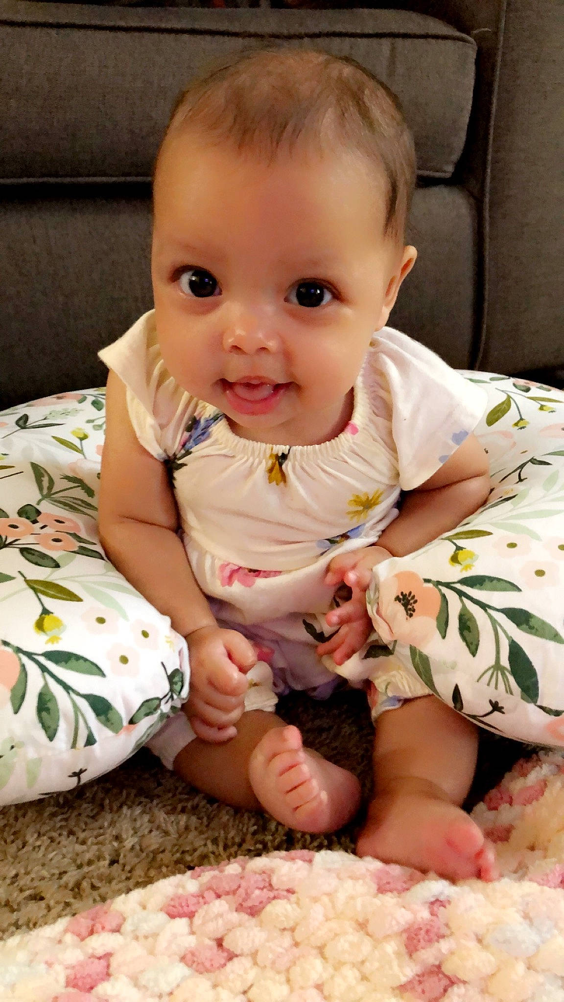 Anniya is registered to the contest to win money with this photo: arm, baby, baby_toddler_clothing, cheek, comfort, dress, facial_expression, finger, hand, head, mammal, person, photograph, pink, skin, sleeve, smile, textile, toddler, vertebrate