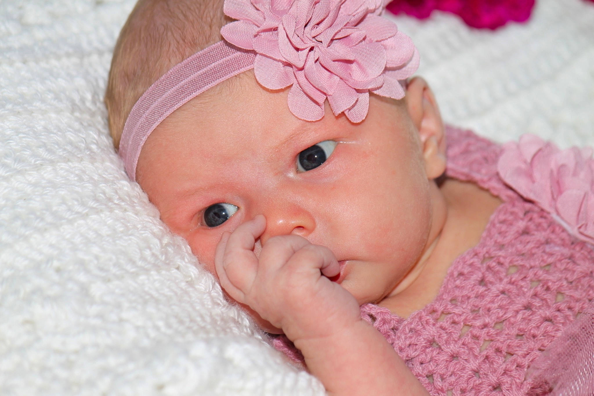 Henley is registered to the contest to win money with this photo: baby, baby_toddler_clothing, cheek, chin, eye, eyelash, finger, flower, gesture, hand, happy, headgear, headwear, iris, lip, nail, person, pink, plant, skin