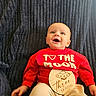 baby, blue_blanket, casual_clothing, celebration, child, cute, eyes, face, happy, infant, lying_down, milestone, portrait, red_sweater, smiling, text_on_clothing, texture, three_months, ufo_illustration, wooden_sign