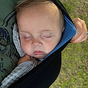 Beau is registered to the contest to win money with this photo: baby, child, closeup, clothing, fabric, face, grass, hand, head, infant, nap, outdoor, peaceful, person, portrait, rest, skin, sleeping, soft, wrap