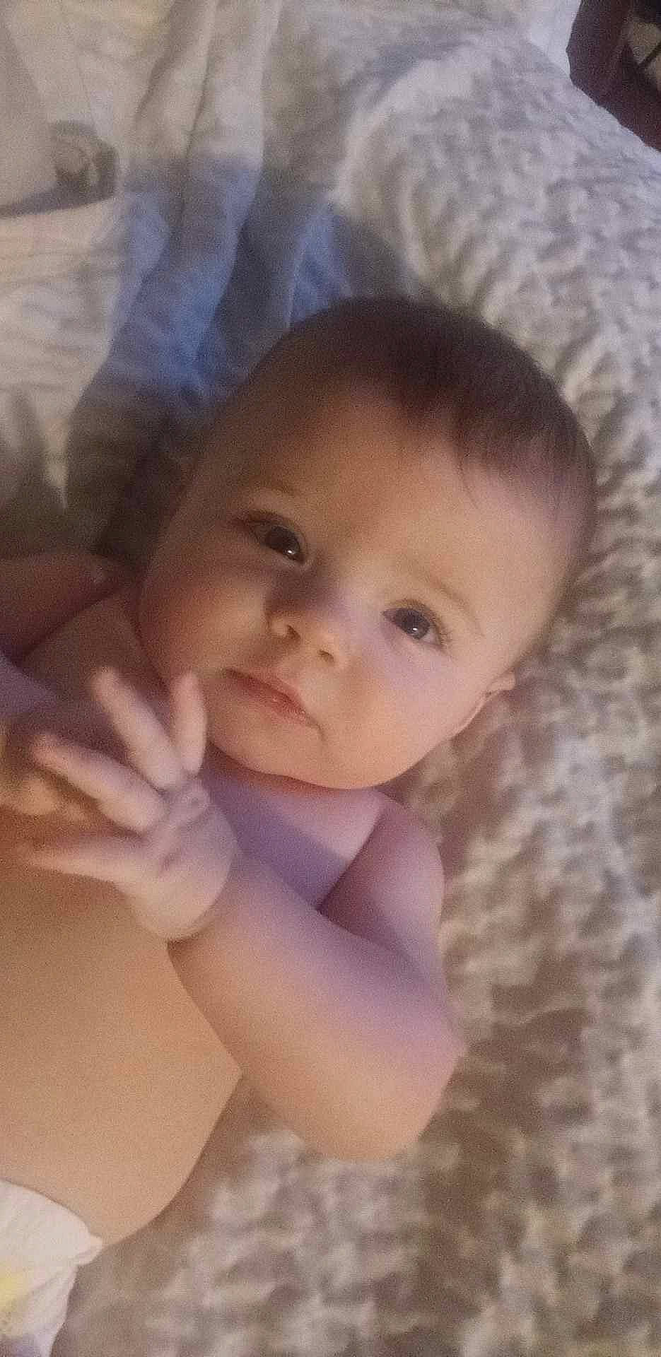 Auria is registered to the contest to win money with this photo: abdomen, baby, baby_toddler_clothing, cheek, chest, child, close_up, comfort, ear, eyelash, gesture, happy, iris, linens, lip, nose, person, skin, smile, thumb