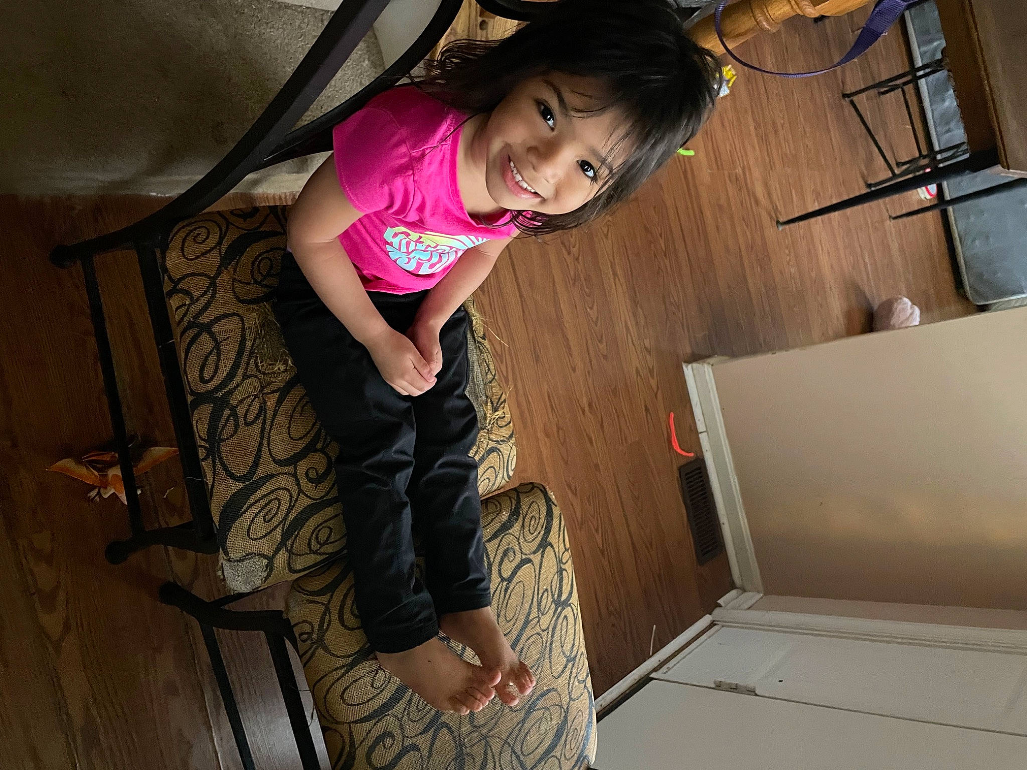 Chloe joined the competition — help win amazing prizes! black_hair, elbow, flash_photography, floor, flooring, happy, hardwood, human_leg, joint, joy, knee, leg, magenta, person, room, smile, sneakers, t_shirt, thigh, toddler