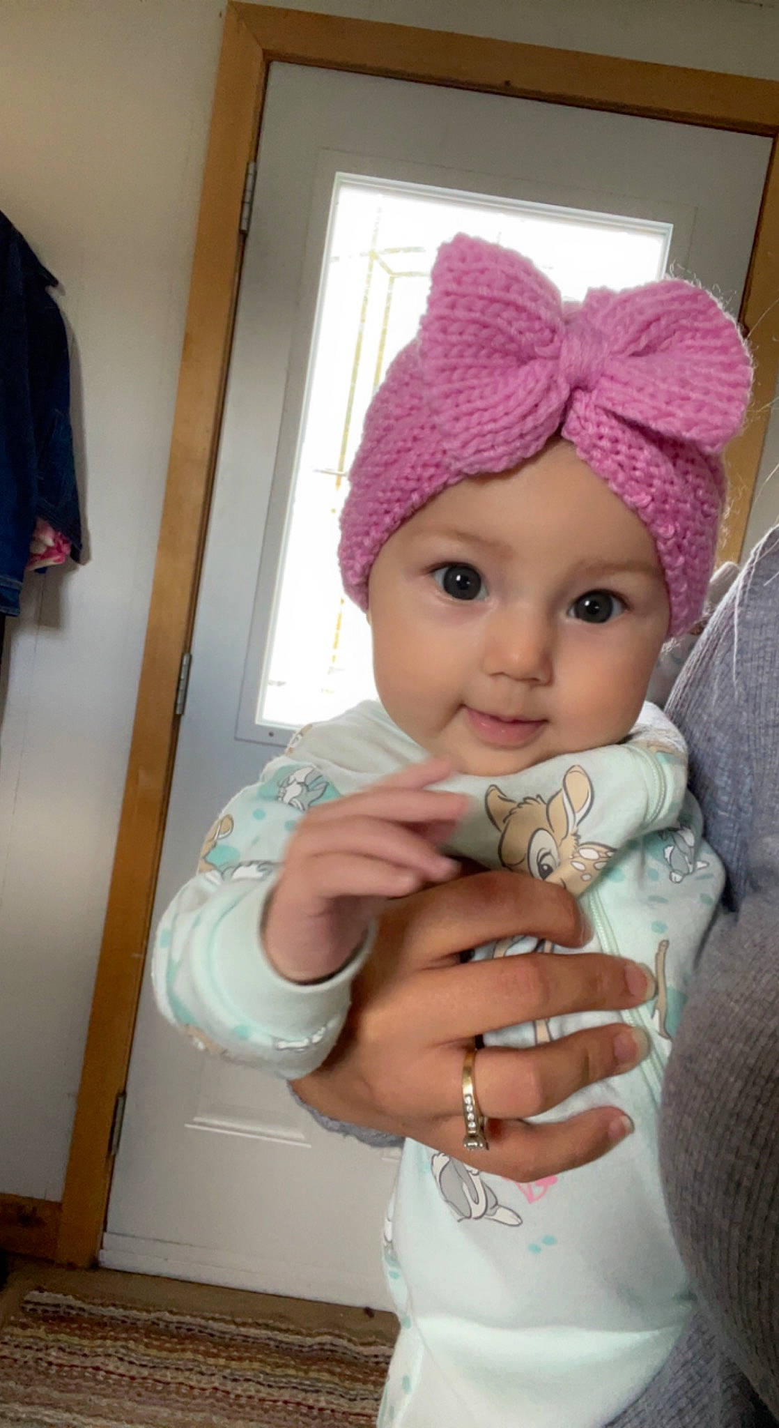 Kylee is registered to the contest to win money with this photo: baby, baby_toddler_clothing, cap, eye, eyebrow, eyelash, gesture, headgear, headwear, jewellery, knit_cap, lip, magenta, pattern, person, pink, sleeve, smile, thumb, toddler