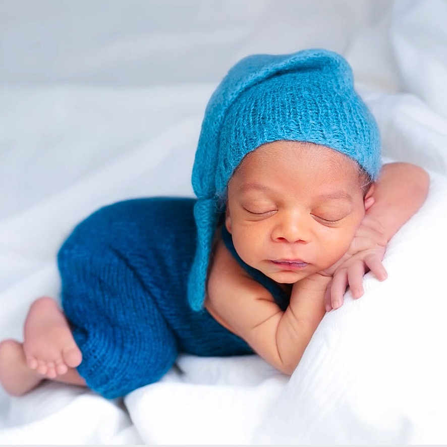 Lucas joined the competition — help win amazing prizes! baby, beanie, blanket, bonnet, cap, clothing, face, happy, hat, head, newborn, person, photography, portrait, sleeping, smile