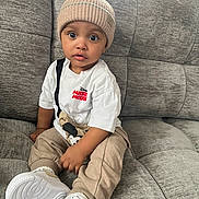 Blair-Ryser joined the competition — help win amazing prizes! beanie, beige_pants, big_eyes, casual_clothing, child, couch, cute, hat, indoor, living_room, mickey_mouse, portrait, sitting, sneakers, sofa, surprised_expression, textured_sofa, toddler, white_sneakers, white_tshirt