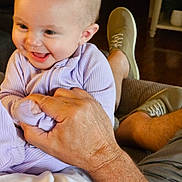 Charlotte is registered to the contest to win money with this photo: baby, child, smiling, happy, person, hand, clothing, purple, sitting, indoor, footwear, shoe, adult, skin, face, head, family, candid, cozy, joy