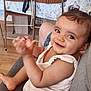 Mélina a rejoint le concours — aidez-le/la à gagner de superbes lots ! baby, child, smile, clapping, indoor, couch, person, face, happy, sitting, furniture, wooden_floor, casual, infant, cute, young_child, hair, clothing, playful, expression