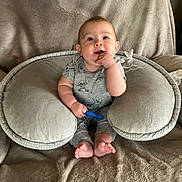 Agnes joined the competition — help win amazing prizes! baby, blanket, child, comfort, cozy, cute, face, foot, grey_clothing, hand, happy, indoors, infant, person, plush_pillow, sitting, smiling, stitch_outfit, toy, young