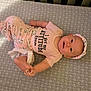 Agnes joined the competition — help win amazing prizes! baby, baby_girl, child, crib, cute, fabric, happy, head, headband, indoors, infant, lying_down, mattress, patterned_pants, person, pink_clothing, portrait, smiling, text_on_clothing, young_child