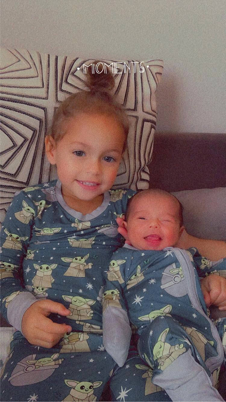 Emberleigh is registered to the contest to win money with this photo: arm, baby, camouflage, chair, cheek, comfort, eye, face, facial_expression, finger, hair, happy, head, iris, joy, mammal, military_camouflage, organ, person, skin