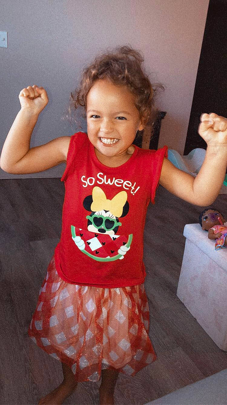 Everleigh joined the competition — help win amazing prizes! arm, baby_toddler_clothing, clothing, finger, gesture, hair, hand, happy, human_body, joint, joy, neck, orange, person, pink, red, shoulder, sleeve, smile, standing