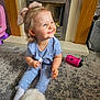 Nyla joined the competition — help win amazing prizes! toddler, child, smiling, bow, blue_clothing, sitting, carpet, fireplace, indoor, toy, sippy_cup, dog, happy, young_child, home, floor, cute, playful, person, pet
