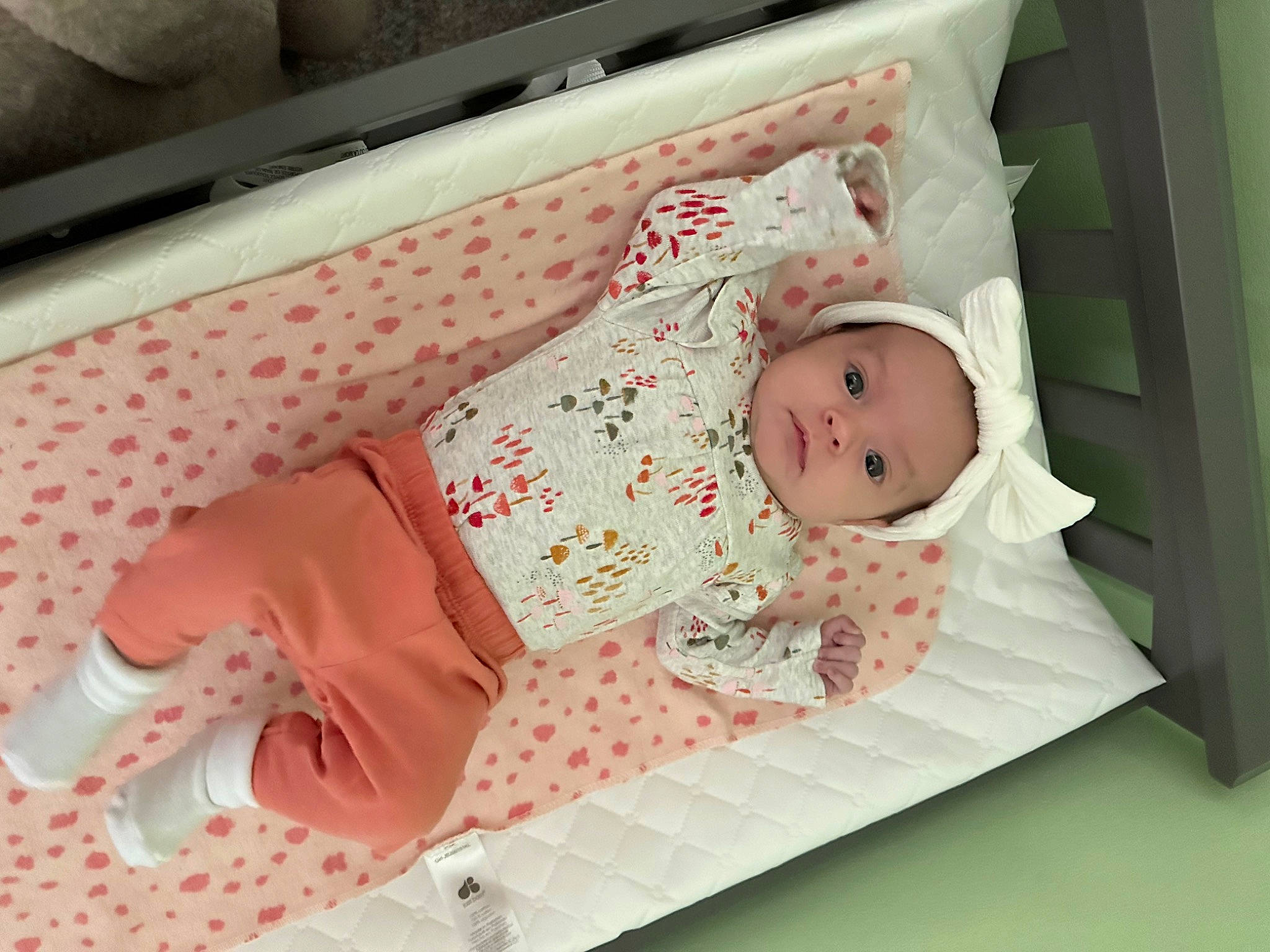 Kaiden is registered to the contest to win money with this photo: baby, baby_products, baby_safety, baby_toddler_clothing, bedding, child, comfort, infant_bed, linens, pattern, peach, person, pink, room, sleeve, toddler