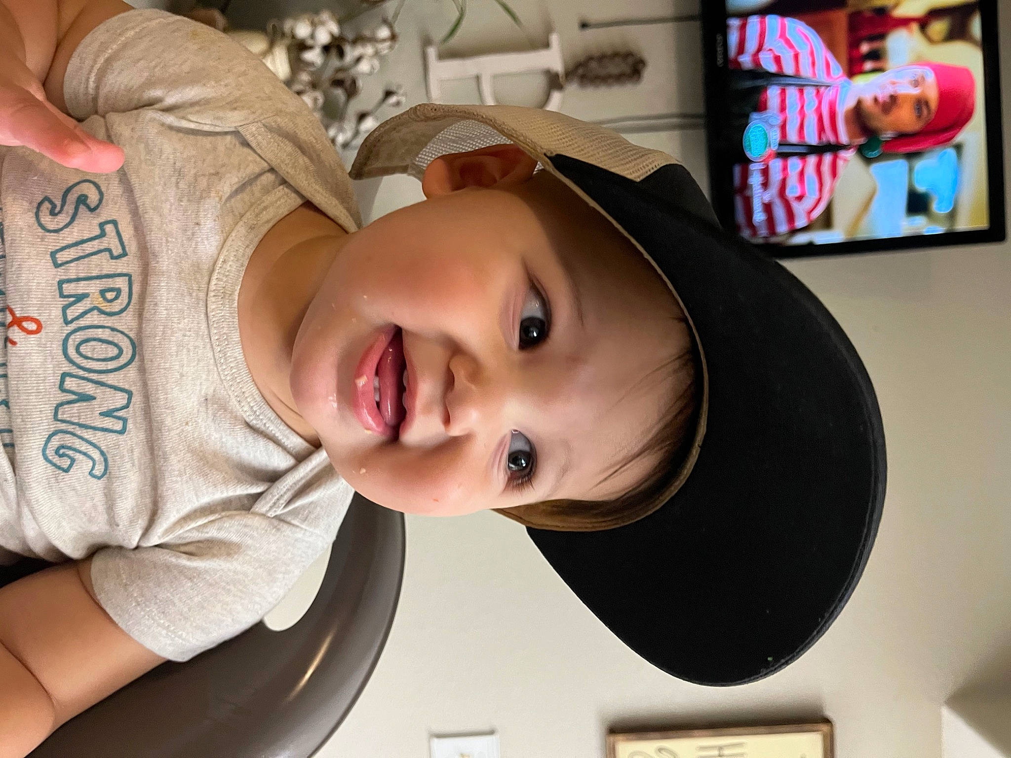 Tobias is registered to the contest to win money with this photo: baby, cap, cheek, child, chin, cool, eyebrow, eyelash, facial_expression, fun, happy, hat, headgear, headwear, lip, mouth, nose, person, product, skin