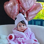 Lucia joined the competition — help win amazing prizes! baby, infant, pink_bathrobe, towel_turban, heart_balloons, rose_gold, indoor, cozy, white_chair, soft_texture, curious_expression, child, portrait, cute, comfortable, decor, window_light, legs, feet, fluffy