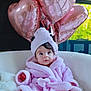 baby, infant, pink_bathrobe, towel_turban, heart_balloons, rose_gold, indoor, cozy, white_chair, soft_texture, curious_expression, child, portrait, cute, comfortable, decor, window_light, legs, feet, fluffy