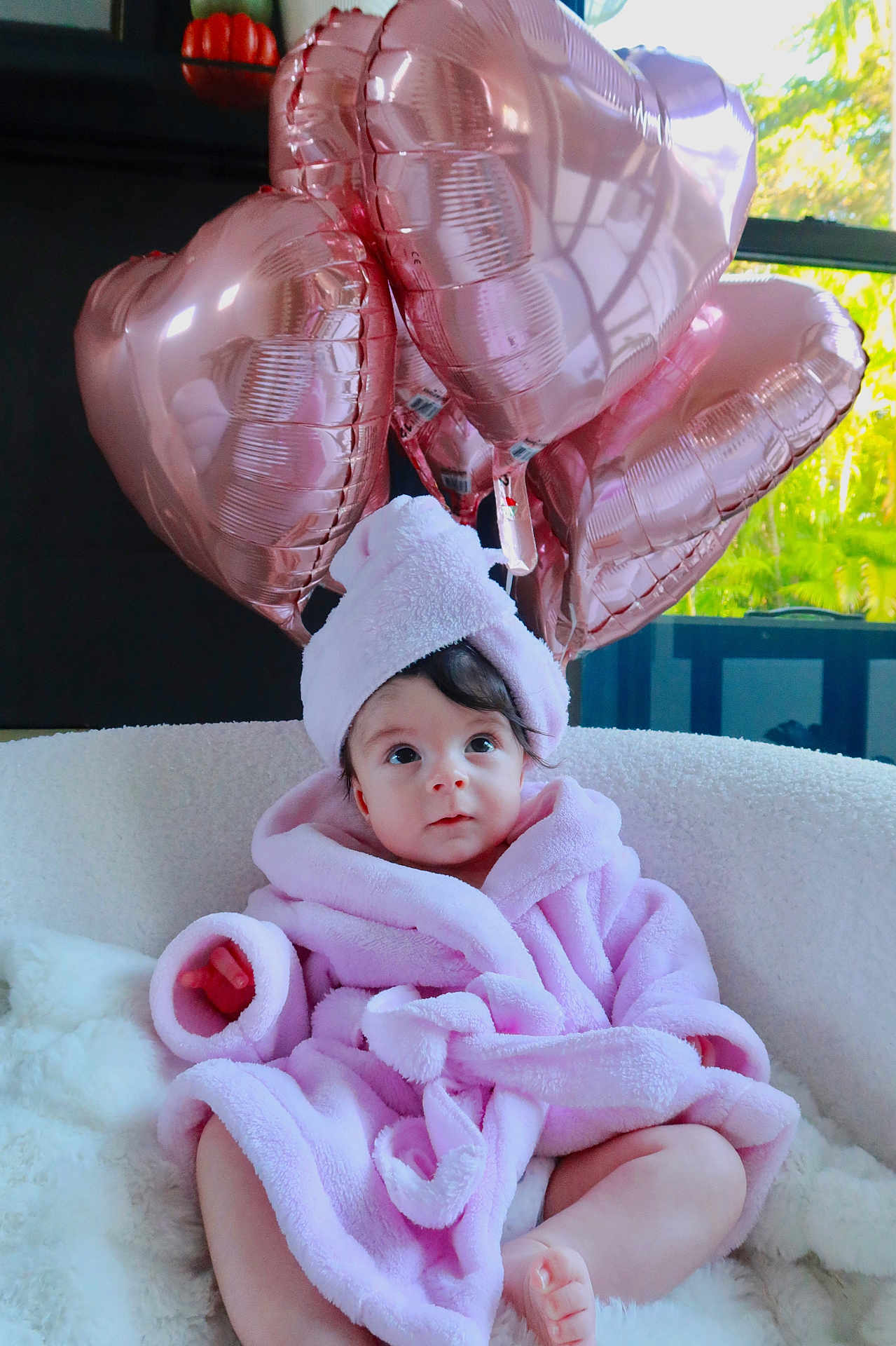 Lucia joined the competition — help win amazing prizes! baby, infant, pink_bathrobe, towel_turban, heart_balloons, rose_gold, indoor, cozy, white_chair, soft_texture, curious_expression, child, portrait, cute, comfortable, decor, window_light, legs, feet, fluffy