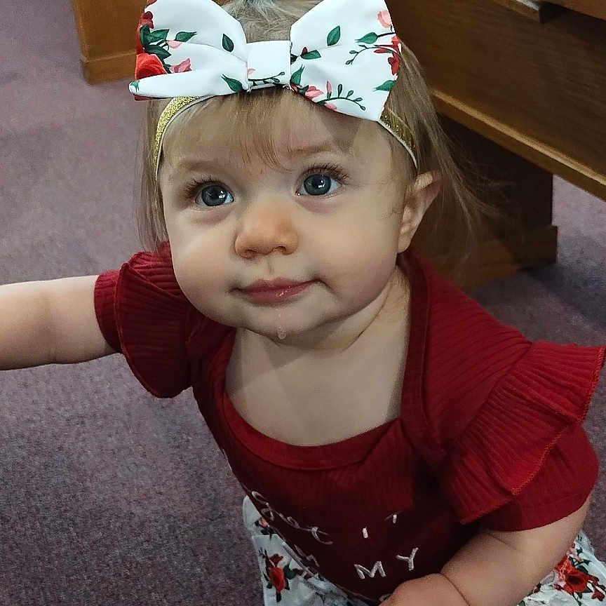 Emma is registered to the contest to win money with this photo: accessories, baby, bodypart, cabinet, clothing, drawer, dress, face, finger, furniture, hand, hardwood, hat, head, headband, person, photography, plywood, portrait, wood