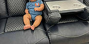 Del'Siah is registered to the contest to win money with this photo: baby, black_leather, blue_onesie, child, comfort, couch, cute, elephant_patch, floor, furniture, happy, home, indoor, infant, person, quilted_stitching, recliner, relaxing, seat, smiling