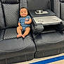 baby, black_leather, blue_onesie, child, comfort, couch, cute, elephant_patch, floor, furniture, happy, home, indoor, infant, person, quilted_stitching, recliner, relaxing, seat, smiling