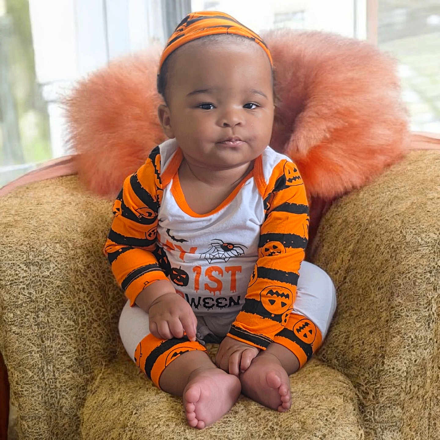 Del'Siah is registered to the contest to win money with this photo: baby, black, chair, child, clothing, costume, cozy, cute, face, foot, halloween, hand, headband, indoor, infant, orange, pillow, portrait, sitting, window