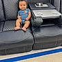 Del'Siah is registered to the contest to win money with this photo: baby, blue_onesie, blue_stripe, child, comfortable, cup_holders, cute, floor_tile, furniture, happy, indoor, infant, leather_chair, person, power_outlets, quilted_pattern, recliner, seated, smiling, tray_table